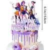 A tiered birthday cake decorated with purple frosting and edible toppers featuring anime-style girl figures.