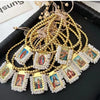 Gold-plated charm bracelet featuring small religious icons and beaded strands