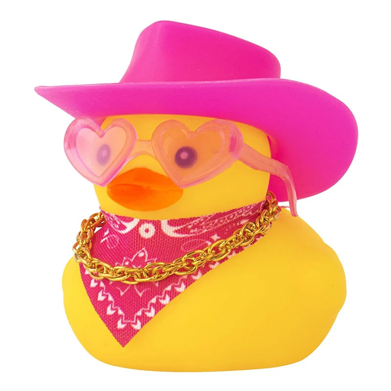 A rubber duck shaped like a yellow bird wearing a pink cowboy hat and a gold chain necklace.