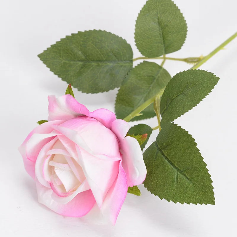 Pink and white velvet artificial roses with bendable stems on a green leaf stem
