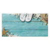 A light blue wooden sign decorated with seashells, starfish, and straw hats.