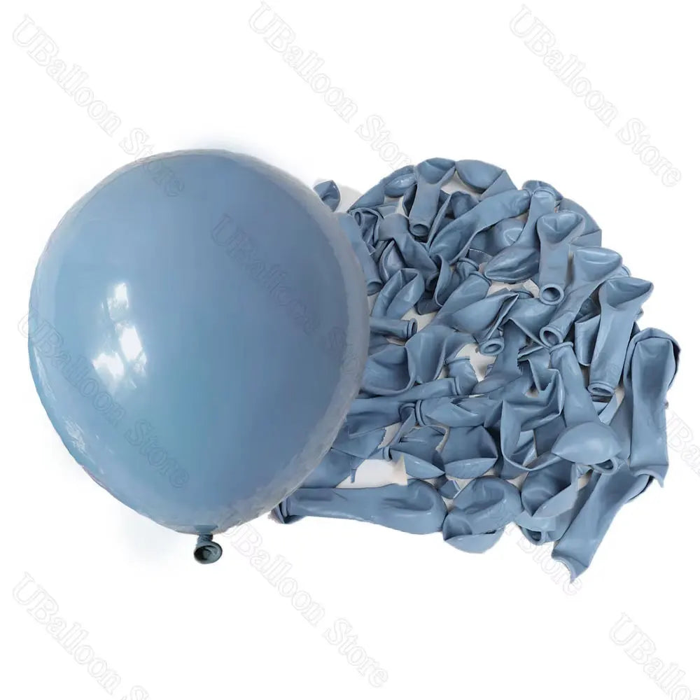 A bunch of light blue latex balloons in neutral shades laid out for decoration.