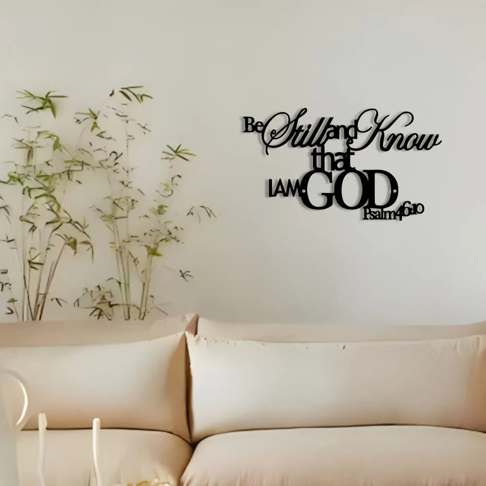 A minimalist metal wall sign featuring the scripture Be Still and Know that I am God