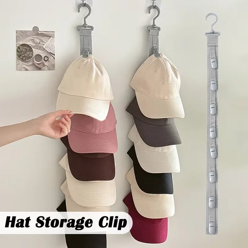 A hand is hanging a beige hat onto a silver clip organizer rack for closet storage.