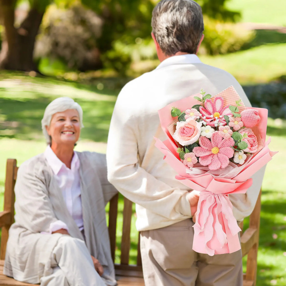 A woman in a light jacket holds a bouquet of handcrafted crochet tulip flowers in pink.