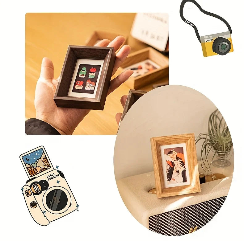A hand holds a wooden photo frame displaying small polaroid pictures, next to a vintage camera.