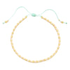 Handmade boho glass bead bracelet with adjustable cord featuring light pink and gold beads.