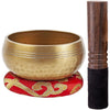 A handcrafted copper singing bowl set featuring a golden bowl and a dark wooden mallet.