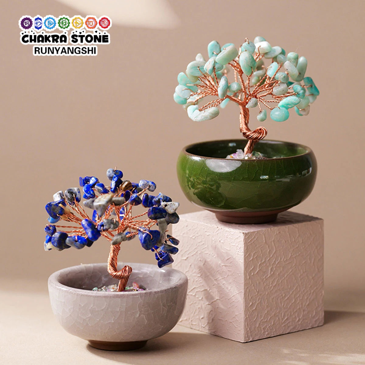 Handcrafted crystal tree with a copper wire base growing out of a green bowl and a light stone dish.