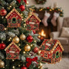 A decorated Christmas tree featuring handcrafted wooden cabin ornaments and red ornaments.