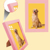 Two pink photo frames display images of golden retriever dogs against a light yellow background.