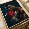 A framed poster featuring a portrait of Muhammad Ali in boxing gloves against a dark background.