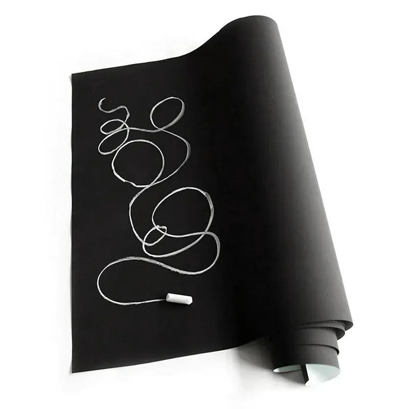 A roll of removable self-adhesive chalkboard wall stickers lying on a white surface.