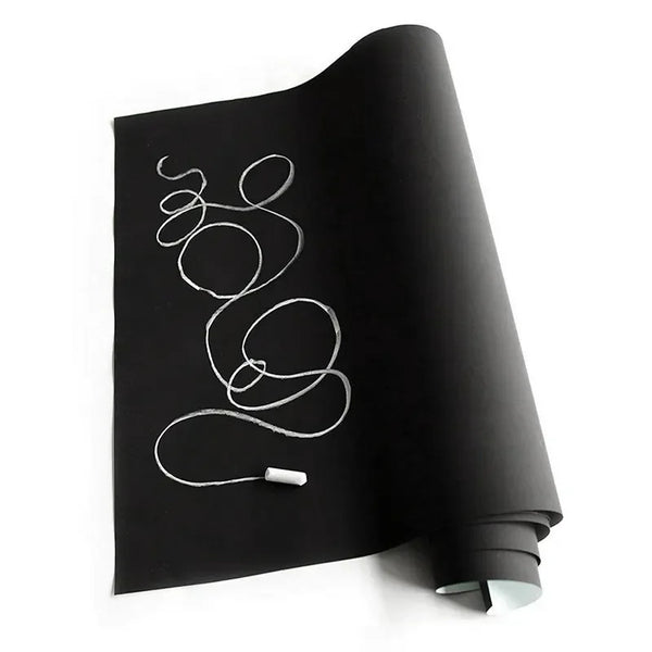A roll of removable self-adhesive chalkboard wall stickers lying on a white surface.