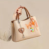 A hand holds a beige nylon rope DIY craft kit bag with leather handles and colorful charms.