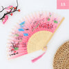 A pink and red vintage silk bamboo folding hand fan with delicate floral designs.