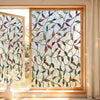 Decorative privacy window film featuring a pattern of colorful leaves and branches in a wooden frame.