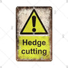 A vintage industrial sign with a yellow triangle warning symbol and the text Hedge cutting on a metal plate.