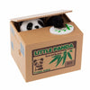A cardboard box containing an interactive coin bank shaped like a panda, featuring bamboo leaves and a barcode.