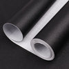 Roll of matte peel and stick decor stickers shown rolled up on a dark surface