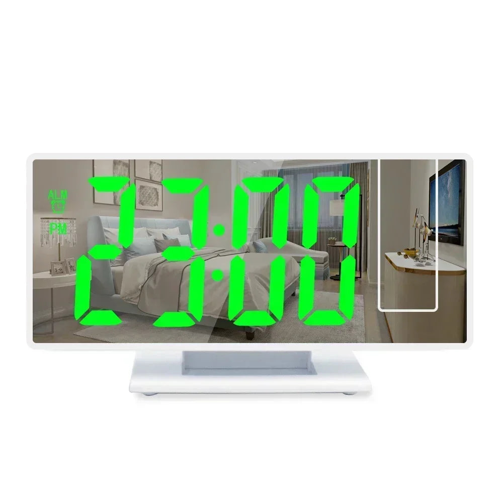A digital projection alarm clock displaying 7:00 AM and 0:00, shown on a white monitor.