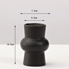 A matte black ceramic vase with a rounded body and narrow opening, shown against a white background.