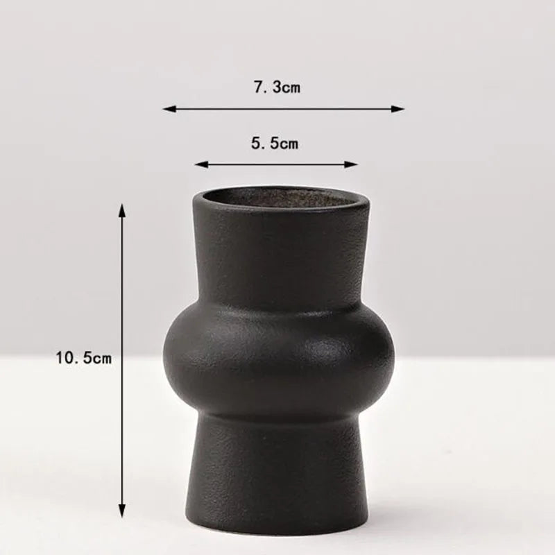 A matte black ceramic vase with a rounded body and narrow opening, shown against a white background.