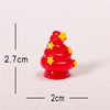 A small, red resin Christmas tree charm decorated with yellow stars, shown against a white background.