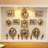 A display featuring ten vintage resin picture frames with various couple portraits and figures.