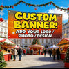 A large orange banner advertising custom banners is displayed outdoors with festive holiday decorations and people in the bac