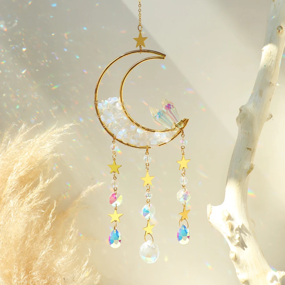 Handcrafted moon crystal suncatcher with a gold crescent and prism pendant hanging from a branch.