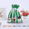 A set of five festive green drawstring Christmas gift bags featuring Santa and snowman designs.