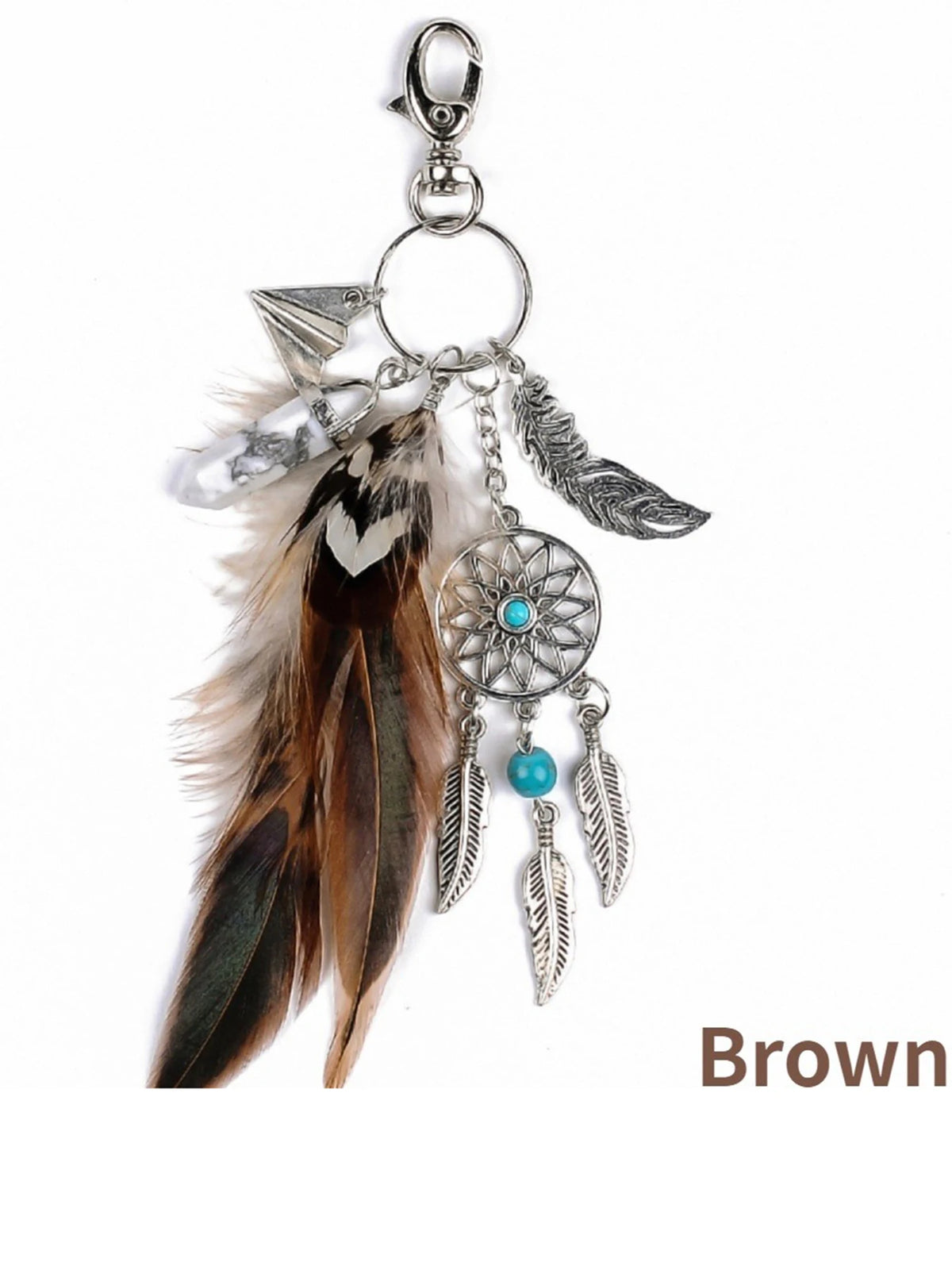 A brown bohemian dream catcher keychain featuring a feather, silver beads, and tassels.