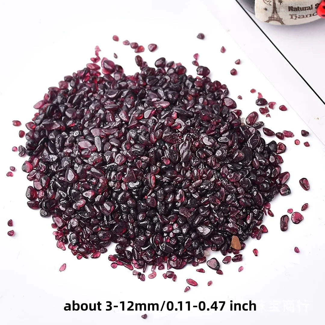 A pile of deep burgundy natural garnet crystal chips for jewelry and decor.
