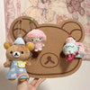 A felt wall decor panel featuring a bear character and several small plush toys.