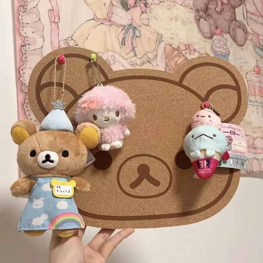 A felt wall decor panel featuring a bear character and several small plush toys.