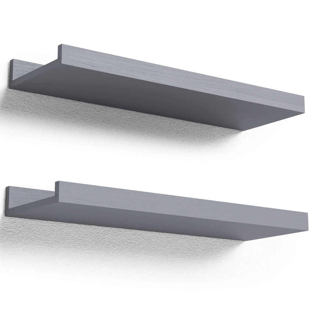 A set of two rustic floating wood shelves in a gray finish mounted on a white wall.