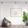 A potted artificial fiddle leaf fig tree in a white pot displayed on a modern interior wall.