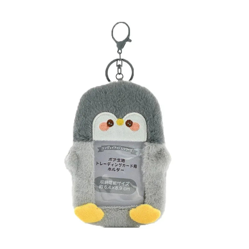 A gray penguin keychain featuring a transparent window design for holding photocards.