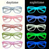 A collection of glow in the dark party glasses in various colors including clear, pink, blue, and green.