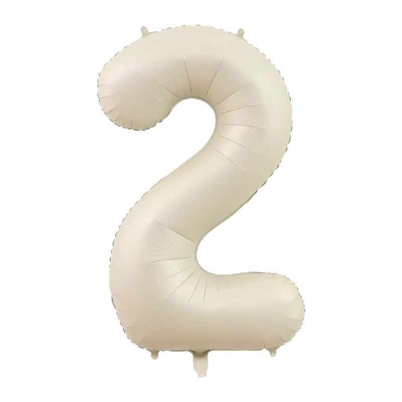 A beige foil number balloon shaped like the number 2.