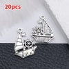 Silver vintage ship anchor charm with a detailed silhouette and a separate ship cutout.
