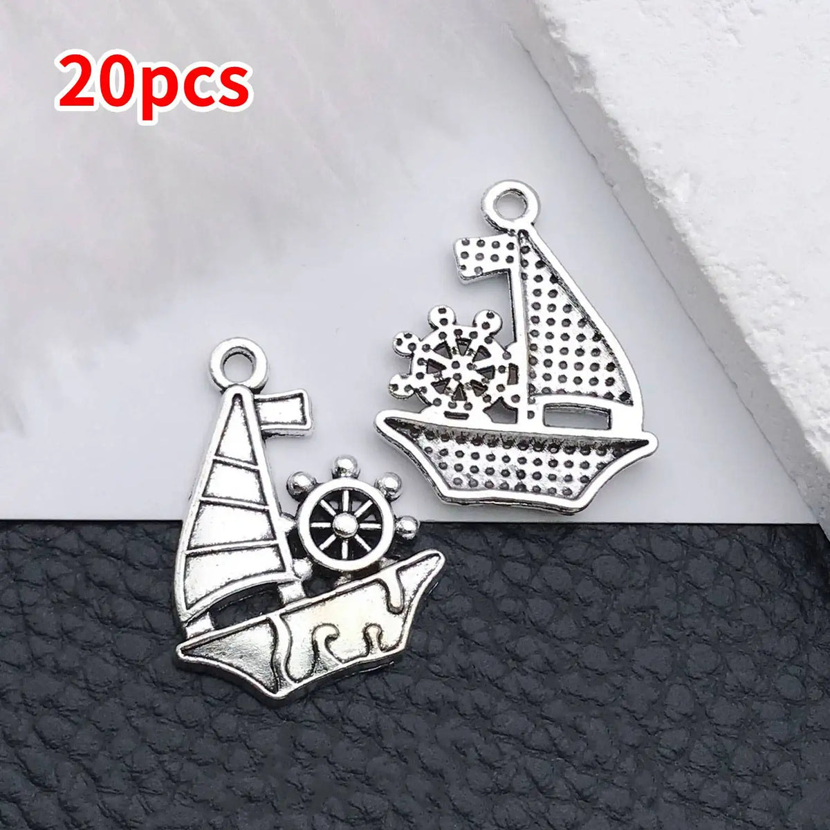 Silver vintage ship anchor charm with a detailed silhouette and a separate ship cutout.