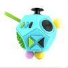 A blue fidget cube with green accents and yellow balls, designed as a sensory desk toy.