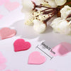 White and pink floral arrangement with heart-shaped sequins confetti