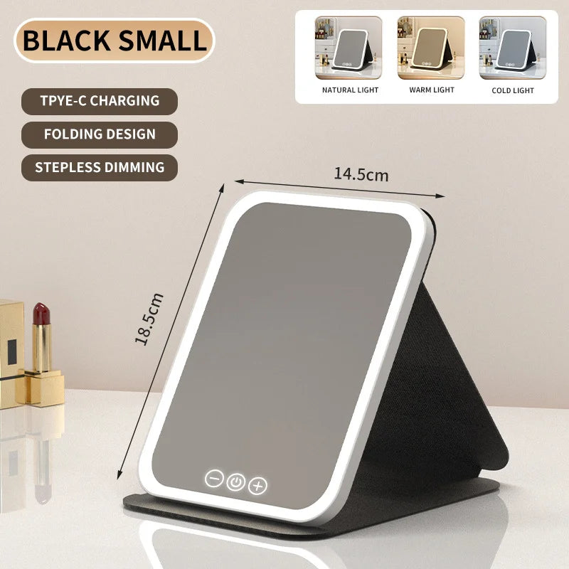 Miroir de maquillage LED noir à gradation avec design pliable montré sur une surface.