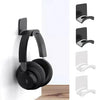 Black adhesive headphone stand mounted on a white wall.