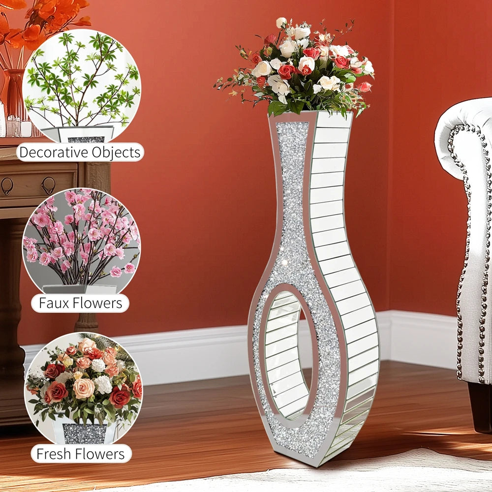 Tall silver mirrored vase with a crushed diamond finish holding fresh flowers.
