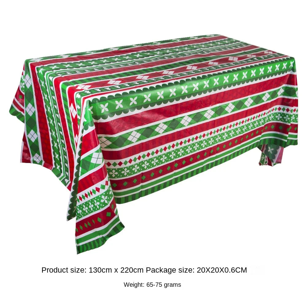 Red and green Halloween tablecloth featuring a pattern of pumpkins, spider webs, and bats.