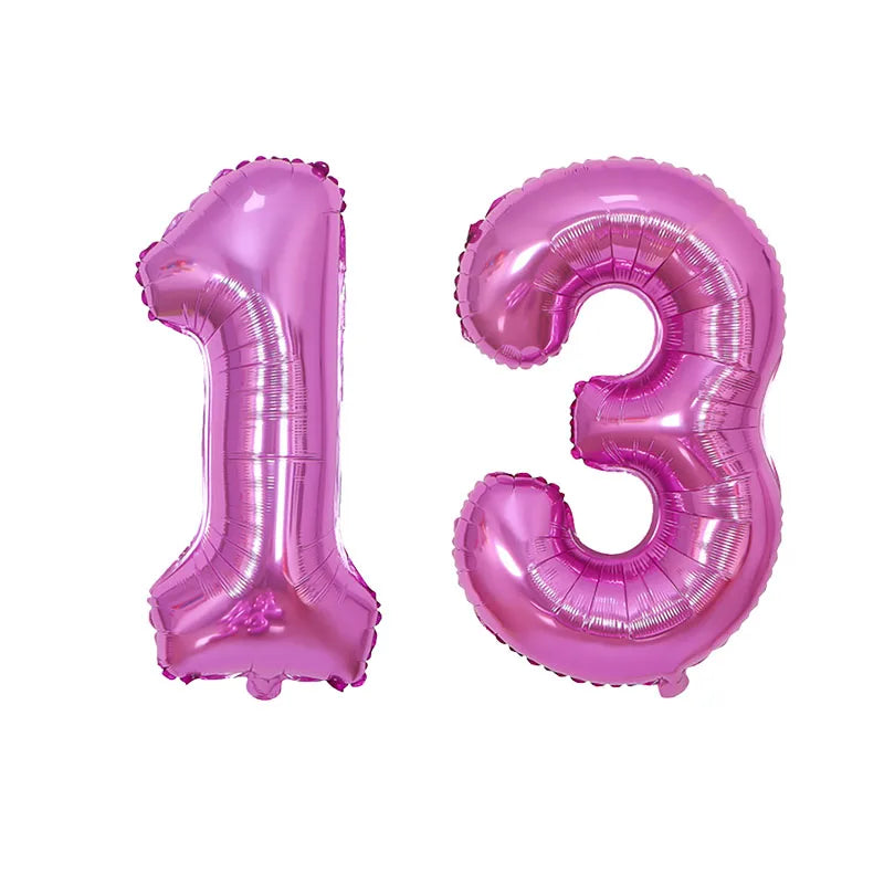 Two foil balloons shaped like the numbers 1 and 3 in pink for birthday party decor